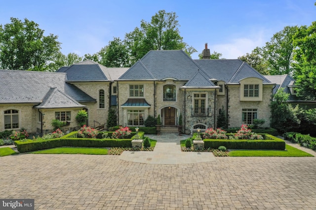 938 Old County Rd, Severna Park, MD 21146 - french provincial home featuring a high end roof, a chimney, and stone siding