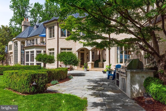 938 Old County Rd, Severna Park, MD 21146 - back of house featuring a balcony, a chimney, and area for grilling