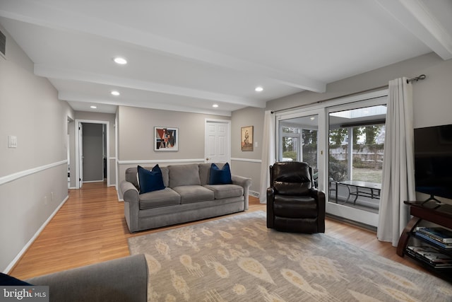 living area featuring beamed ceiling, recessed lighting, wood finished floors, and baseboards