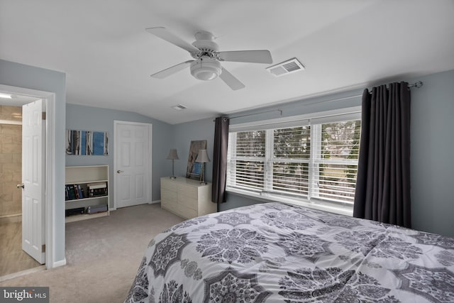 bedroom featuring ceiling fan, visible vents, vaulted ceiling, and light colored carpet