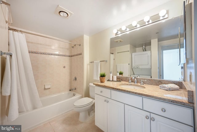 full bathroom with stacked washer and dryer, toilet, tile patterned floors, shower / bath combination with curtain, and vanity