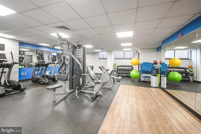 workout area featuring a paneled ceiling