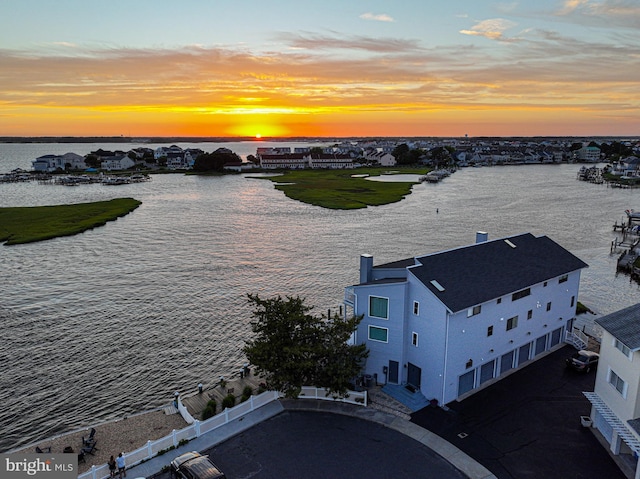 aerial view at dusk with a water view