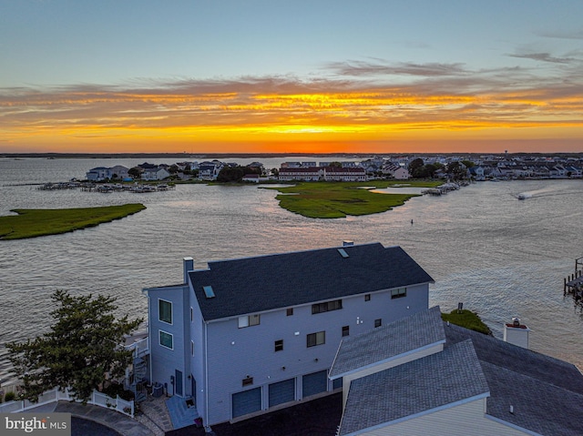 aerial view at dusk with a water view