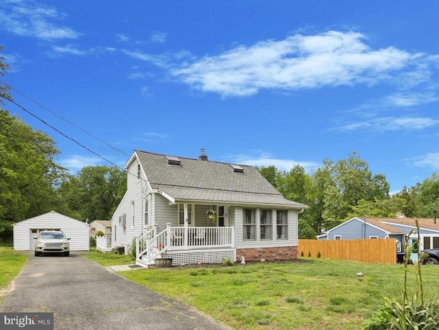 2832 Larkin Rd, Upper Chichester, PA 19061 - view of front of home with covered porch, an outbuilding, a garage, a chimney, and asphalt driveway