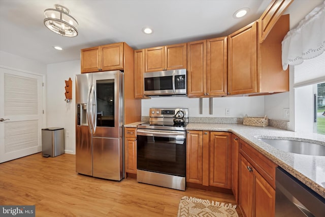 2832 Larkin Rd, Upper Chichester, PA 19061 - kitchen featuring stainless steel appliances, light wood-type flooring, light stone counters, recessed lighting, and a sink