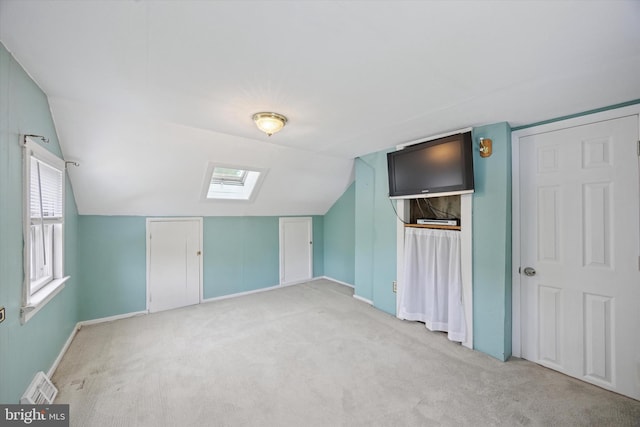 2832 Larkin Rd, Upper Chichester, PA 19061 - additional living space with a skylight, vaulted ceiling, light carpet, and baseboards