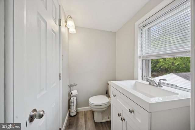 2832 Larkin Rd, Upper Chichester, PA 19061 - bathroom featuring toilet, wood finished floors, vanity, and baseboards