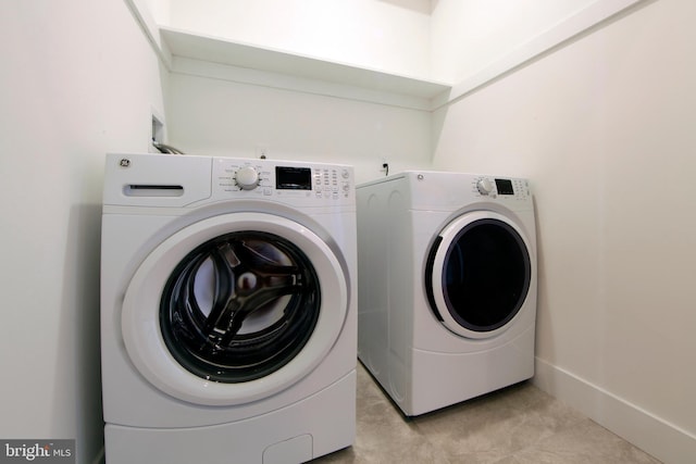 washroom featuring washing machine and dryer