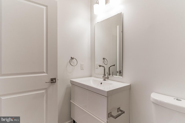 bathroom featuring toilet and vanity