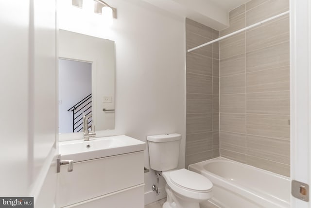 full bathroom with toilet, vanity, and tiled shower / bath combo