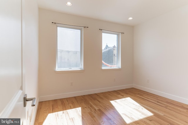 spare room featuring light hardwood / wood-style flooring