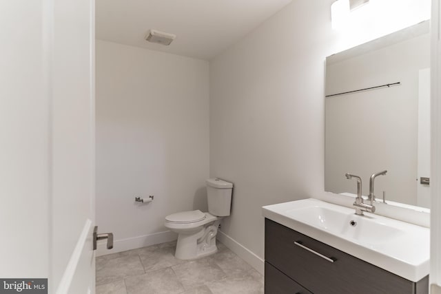 bathroom featuring vanity, tile patterned flooring, and toilet