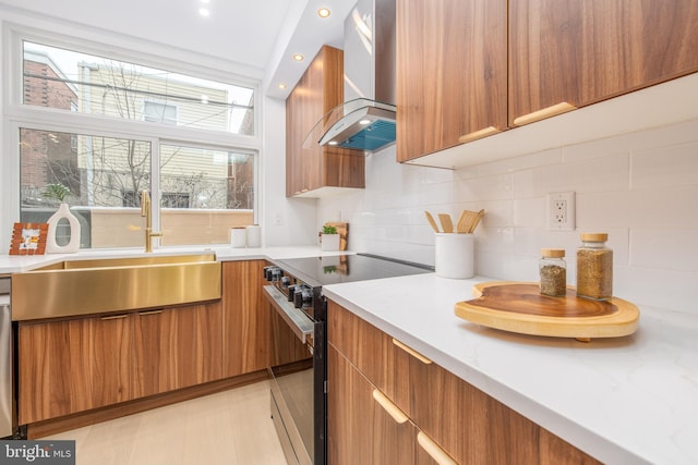 kitchen with appliances with stainless steel finishes, brown cabinetry, a sink, modern cabinets, and extractor fan