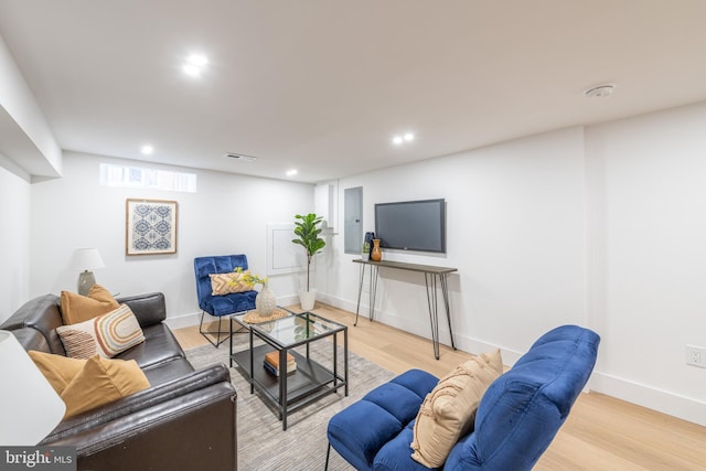 living room with light wood-style floors, recessed lighting, visible vents, and baseboards