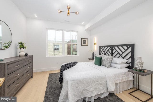 bedroom with light wood-type flooring, visible vents, baseboards, and recessed lighting