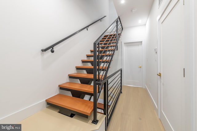 stairs featuring baseboards and wood finished floors