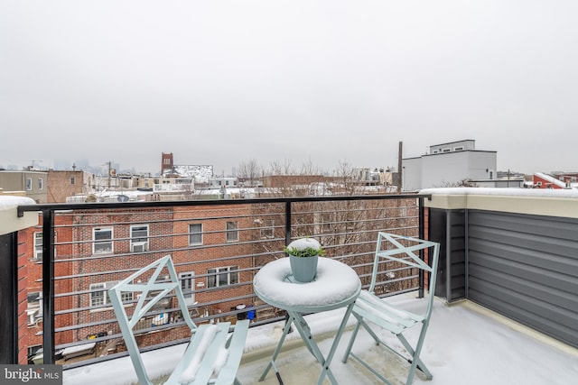 view of snow covered back of property