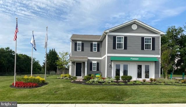 view of front facade with a front lawn and french doors