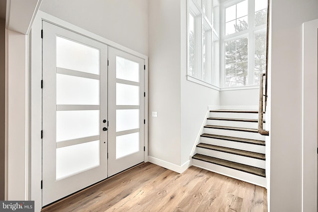 entrance foyer featuring light wood-type flooring and french doors