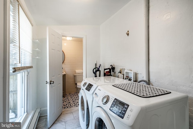 clothes washing area with marble finish floor, independent washer and dryer, and a baseboard radiator