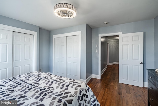 bedroom with dark wood-style flooring and baseboards