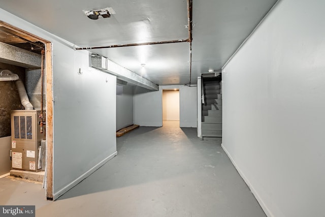 finished basement featuring visible vents, stairway, and baseboards