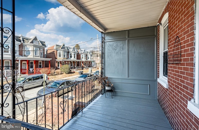 balcony featuring covered porch and a residential view