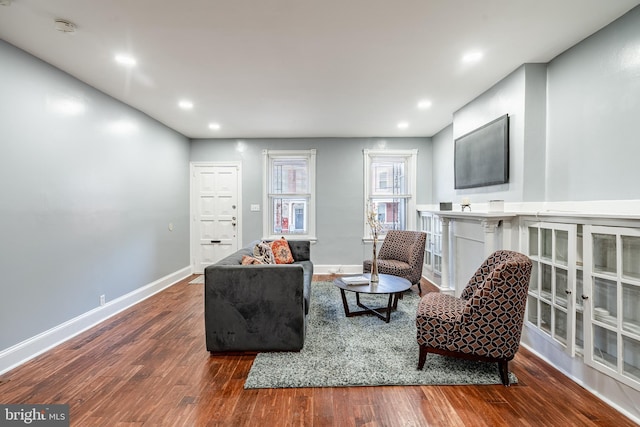 sitting room featuring dark wood-style floors, baseboards, and recessed lighting