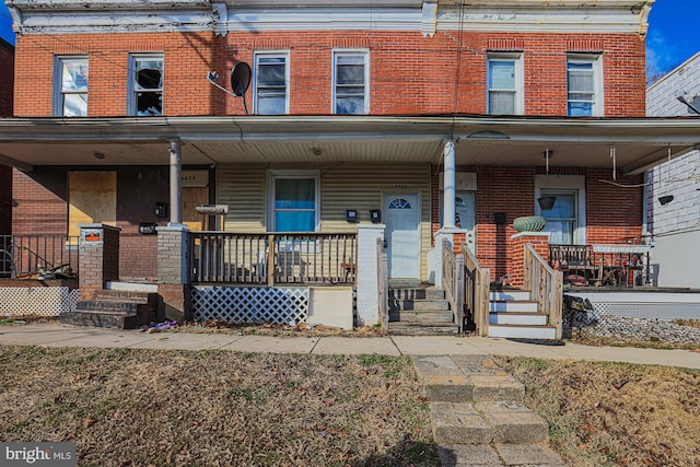 multi unit property with covered porch and brick siding