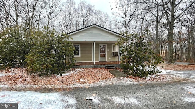 view of front of home with covered porch and cooling unit