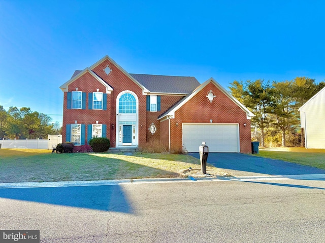 view of front facade with a front yard and a garage