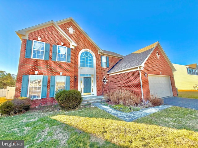 view of front of property featuring a front lawn and a garage