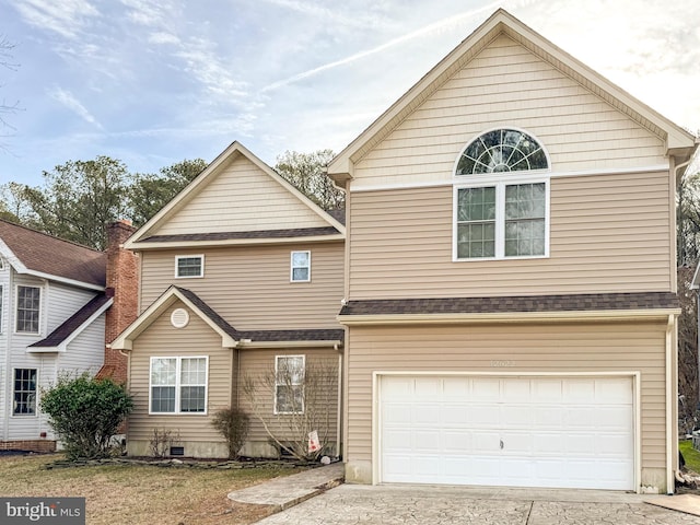 traditional home with concrete driveway, roof with shingles, and an attached garage