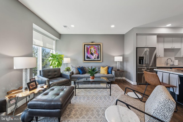 living room featuring sink and hardwood / wood-style floors