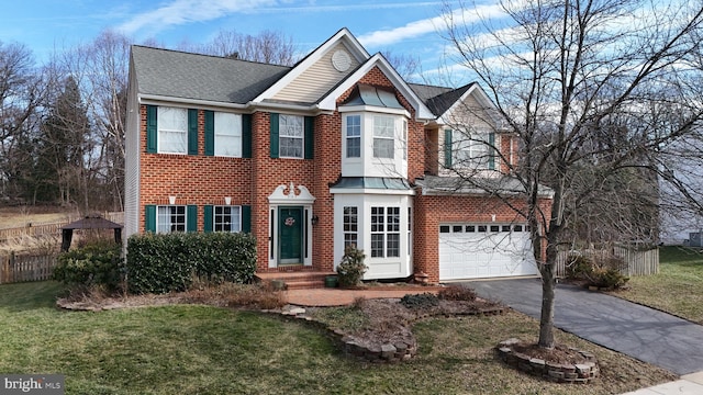 view of front of home with a garage and a front lawn