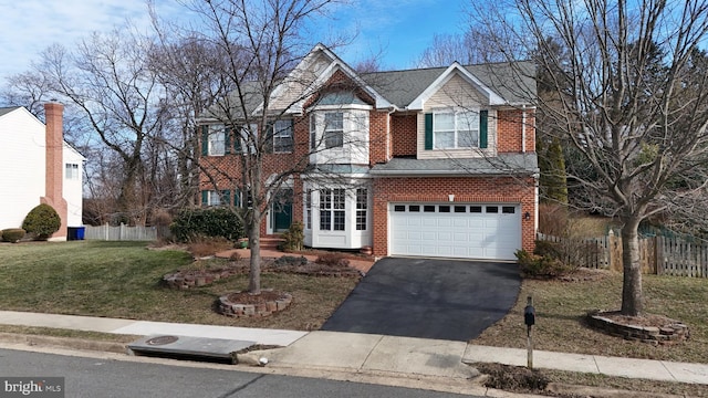 view of front of home with a front yard and a garage