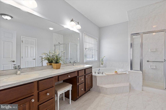 bathroom with double vanity, a stall shower, a bath, and a sink