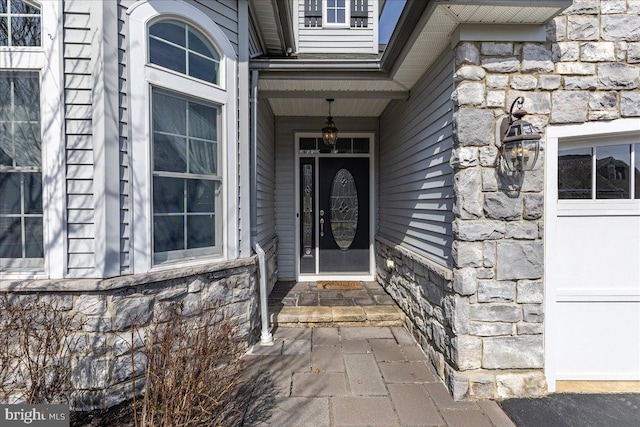 doorway to property featuring stone siding