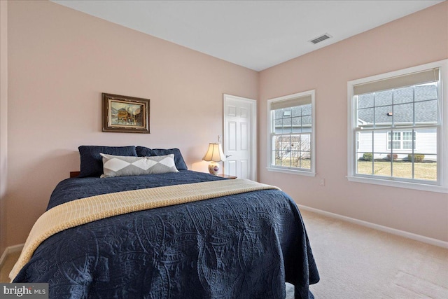 bedroom featuring visible vents, carpet floors, multiple windows, and baseboards