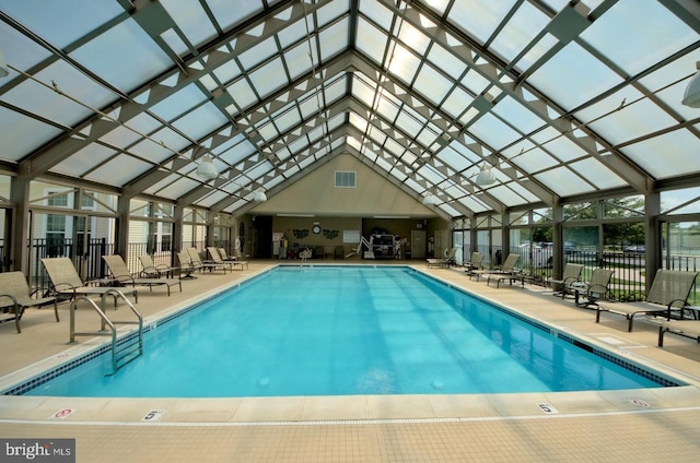 community pool with a patio area, a lanai, and fence