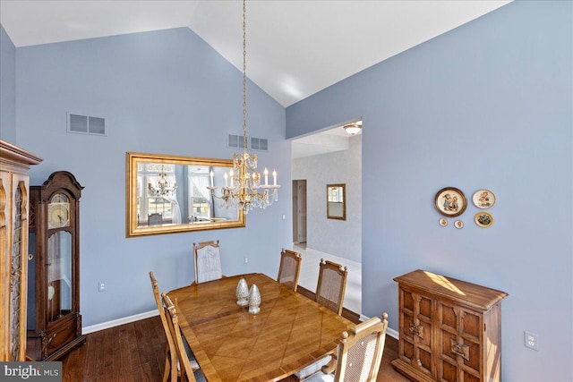 dining area featuring visible vents, high vaulted ceiling, an inviting chandelier, and wood finished floors