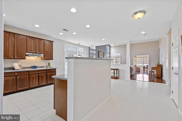 kitchen featuring visible vents, under cabinet range hood, recessed lighting, stovetop, and light countertops