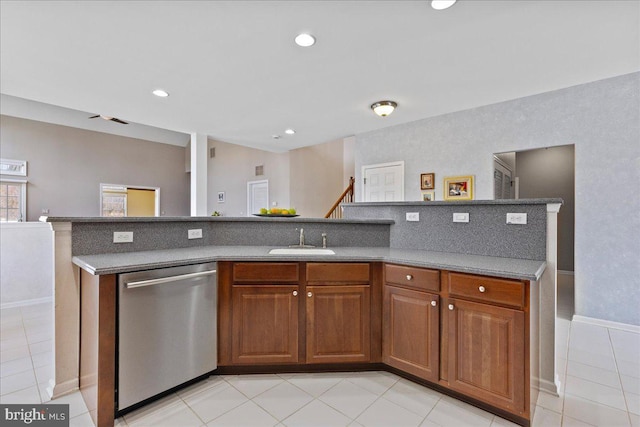 kitchen with light tile patterned floors, brown cabinetry, recessed lighting, a sink, and stainless steel dishwasher