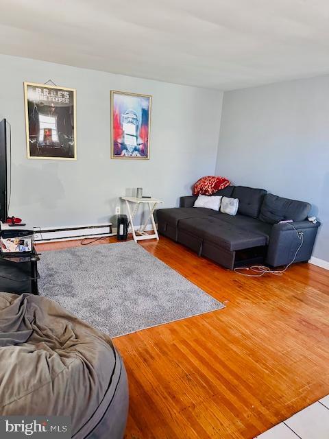 living room featuring hardwood / wood-style floors and baseboard heating