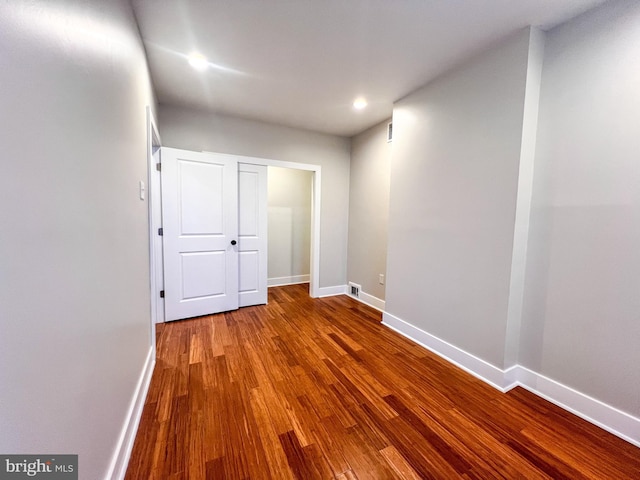 spare room with hardwood / wood-style flooring