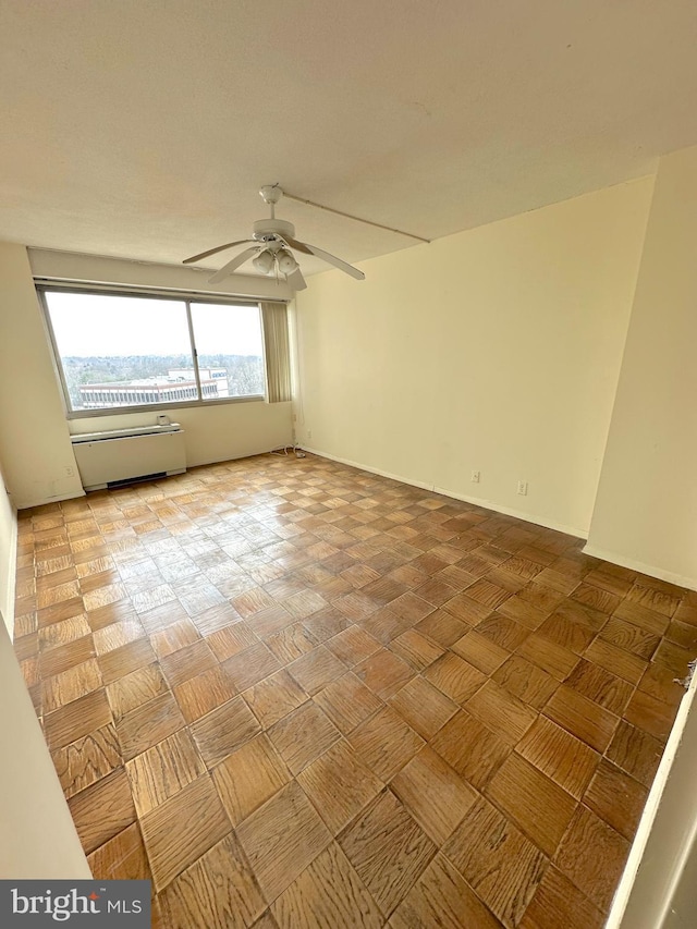 unfurnished room featuring parquet flooring and ceiling fan