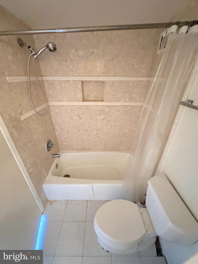 bathroom featuring tile patterned flooring, toilet, and shower / tub combo