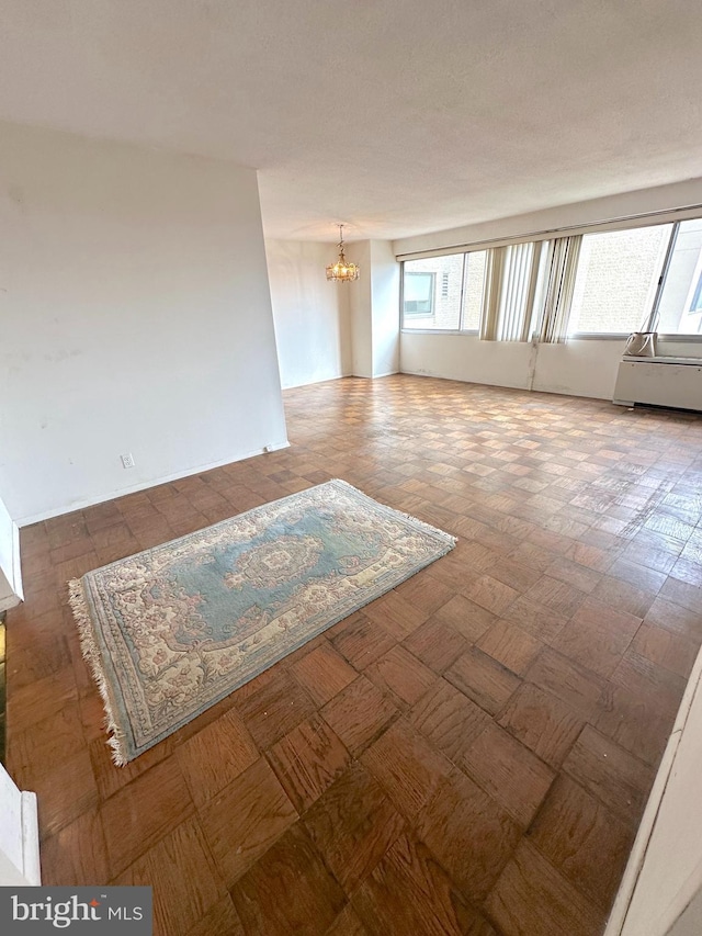 spare room featuring a chandelier