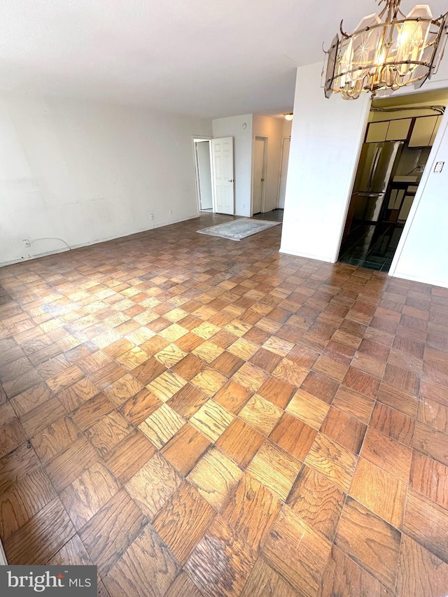 empty room featuring a chandelier